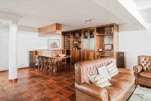 a living room with a couch and a table at Viana Beach Surf House in Viana do Castelo
