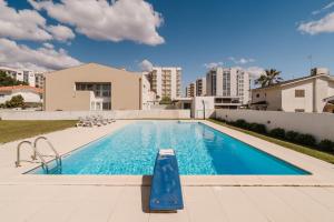 a swimming pool in the backyard of a apartment at Viana Beach Surf House in Viana do Castelo
