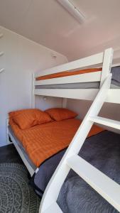 a bedroom with two bunk beds with an orange bed at City Farmer Farmyard Stays, Sleep Easy, Stay Rural, Explore Amsterdam in Amsterdam