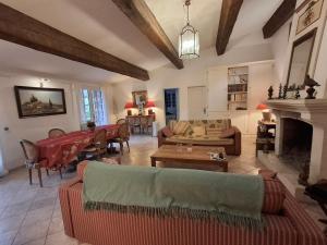 a living room filled with furniture and a fireplace at La Bergerie in Saint-Raphaël