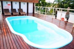 a swimming pool on the deck of a house at Hotel Dois H in Joinville