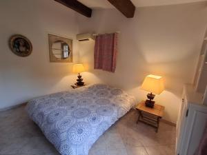 a bedroom with a bed and two lamps on tables at La Bergerie in Saint-Raphaël +7 photos