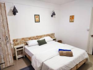 a bedroom with a bed with white sheets at The Rustic Vintage Suite in Grand Baie +68 photos