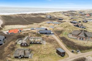an aerial view of a village with houses and the ocean at Feriehus 1107 in Ringkøbing