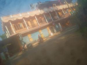 a man sitting on a motorcycle in front of a building at Sscouples in Varkala