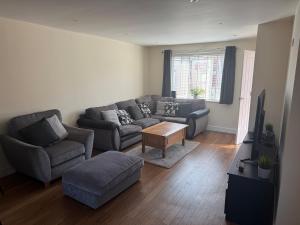a living room with a couch and a table at Crombie House in Lincoln