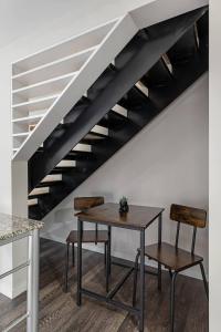 a table and two chairs under a staircase at CBD OTR Pool Gym Free Parking Steps to Stadiums in Cincinnati +47 photos