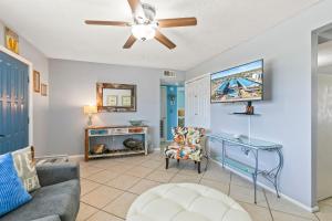 a living room with a couch and a ceiling fan at 2BR Condo w Pool Beach Access and Walk to Hangout in Gulf Shores