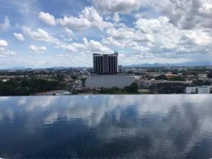 a large pool of water in front of a city at Cozy Stays Studio C - Kozi Square Kuching in Kuching