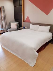 Postel nebo postele na pokoji v ubytování 愛菲爾Motel