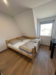 a bedroom with a bed in a room with a window at Bestdrive Pokój 9 in Babienica