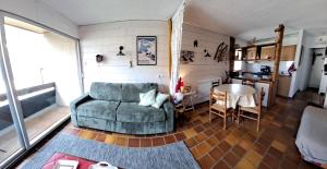 a living room with a chair and a table at L'appart de Saint-Lary in Saint-Lary-Soulan