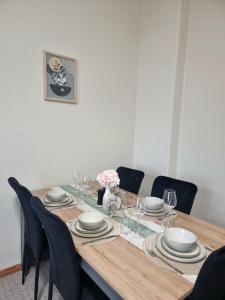 a dining room table with plates and wine glasses at Bahnhofsnahes Altstadt-Paradies in Cottbus +17 photos