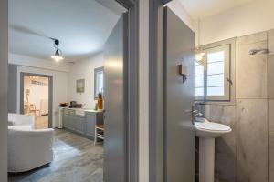 a bathroom with a sink and a toilet in a room at Villa Vireya in Naousa +44 photos