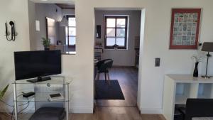 a living room with a television and a table at Am Diemelradweg in Warburg +13 photos