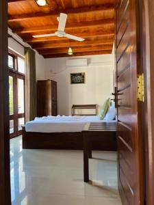 a bedroom with a bed and a ceiling at Kamatha Hotel & Restaurant in Ambalantota