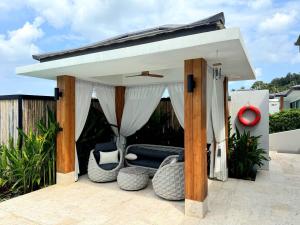 a gazebo with a couch on a patio at Sunterra villa in Nathon Bay