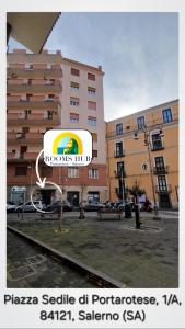 a sign in front of a large building at Rooms hub Portarotese in Salerno