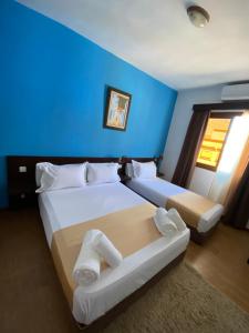 Postel nebo postele na pokoji v ubytování Hotel Chaouen