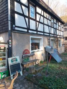 a building with a window and a bench and a table at Ruhig und spartanisch Wohnen in Lichtenwalde 2 in Lichtenwalde +22 photos