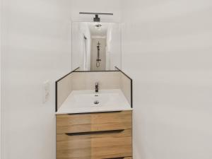 a bathroom with a sink and a mirror at Plage de la Grève Blanche à 600m - Maison pour 8 in Le Guilvinec