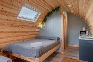 a bedroom with a bed in a wooden room at Wyke Lodges - Pod 2 in Guisborough +11 photos
