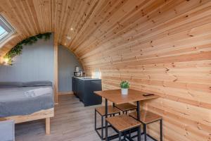 a room with a bed and a wooden wall at Wyke Lodges - Pod 2 in Guisborough