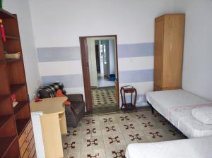 a room with a bed and a mirror at Old Merchant's Home in Cádiz