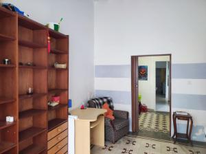 a living room with a table and a chair and a mirror at Old Merchant's Home in Cádiz