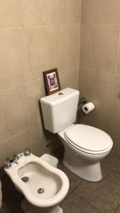 a bathroom with a white toilet and a sink at VENTANAS AL MAR in Mar del Plata