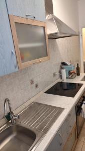 a kitchen with a sink and a counter top at Room&Board 2 Bedrooms up to 7 beds 1 Bathroom in Voghera