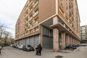 two people standing in front of a building at Silver Azzo Gardino n 9 interno 4-3 in Bologna