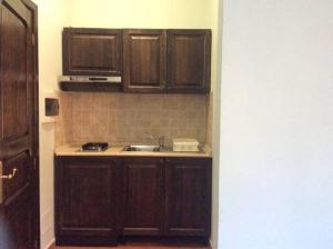 a kitchen with wooden cabinets and a sink at B&B Spano' in Reggio di Calabria