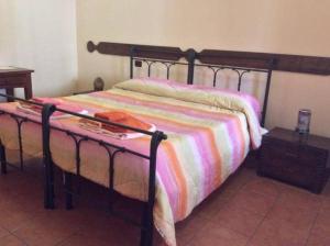 - une chambre avec un lit et une couverture colorée dans l'établissement B&B Spano', à Reggio de Calabre