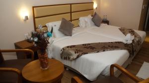 Postel nebo postele na pokoji v ubytování Kani Residency Hotel