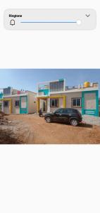 a car parked in front of a house at Vibeesh Villa in Yelagiri