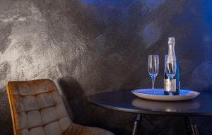 a table with a bottle of champagne and two wine glasses at Private wellness club in Prešov