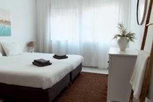 a hotel room with a bed and a window at Balili Beach House in Ferrel