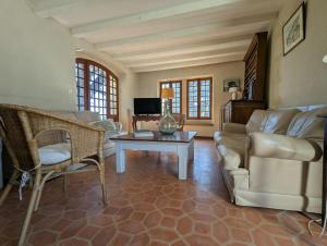 a living room with a couch and a table at Large Provençal Bastide - With Private Pool in Cucuron