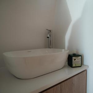 a white sink sitting on a counter in a bathroom at Mitatos "Matthew" in Moutsoúna +42 photos