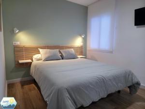 a bedroom with a large bed and a television at Sunny Churriana City in Málaga