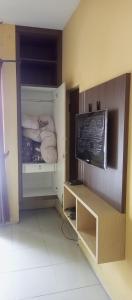 a room with a room with a bed and a tv at Atmawidjaja house in Jakarta