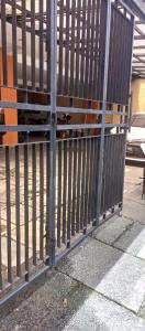 a metal fence next to a sidewalk with at Atmawidjaja house in Jakarta