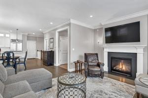 a living room with a couch and a fireplace at Elegant Condo-Steps from Wrigley Field, 32 Nights condo in Chicago