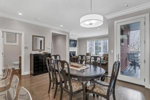 a dining room and living room with a table and chairs at Elegant Condo-Steps from Wrigley Field, 32 Nights condo in Chicago +17 photos