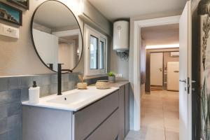 a bathroom with a sink and a mirror at MiMa Loft in Milano Marittima +22 photos