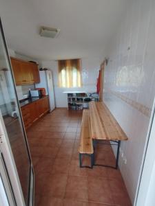 a kitchen with a wooden table in a room at Valencia, villa, piscina privada, junto A-7 cerca de playas, aeropuerto, Cheste in Torrent