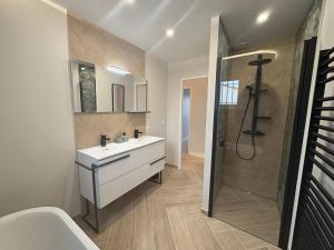 a bathroom with a white sink and a shower at Maison Aiméo en Camargue in Arles +35 photos