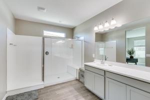 a white bathroom with a shower and a sink at Maricopa Home with Yard - 1 Mi to Harrahs Casino! in Maricopa +17 photos