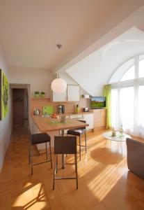 a kitchen with a table and chairs in a room at Ferienwohnungen Merkle in Wasserburg am Bodensee